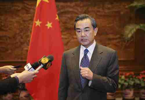 China's foreign minister Wang Yi bares his teeth in a scathing TV interview criticizing Abe's visit to Yasukuni Shrine (Xinhua)