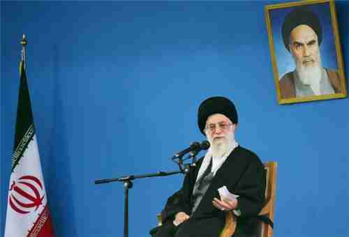 Ayatollah Khamenei, sitting underneath a picture of his predecessor, Ayatollah Khomeini (Fars)