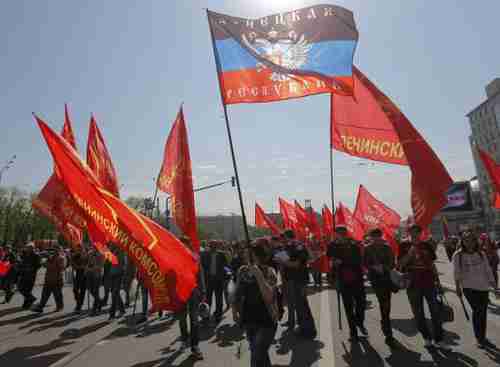 At Mayday rally, banners include the flag of the self-declared 'People's Republic of Donetsk [Ukraine]' (Reuters)