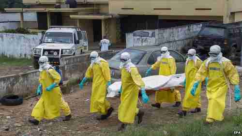 Health care workers in Liberia carry the body of an Ebola victim (EPA)