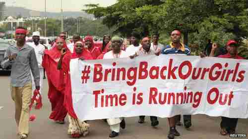 Nigerians carrying 'Bring back our girls' banner (Reuters)