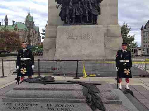 A Twitter user took this photo moments before the shooting.  He tweeted: 'Ok so we were on a tour at that war monument in Ottawa a few minutes ago, a few seconds later there was a shooting.' Is one of these guards the soldier who was killed? (@Evanem/Toronto Star)