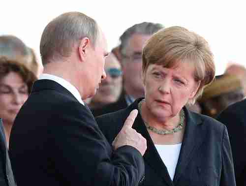 Putin wags his finger at Merkel at the 70th anniversary of D-Day commemoration in June (Reuters)