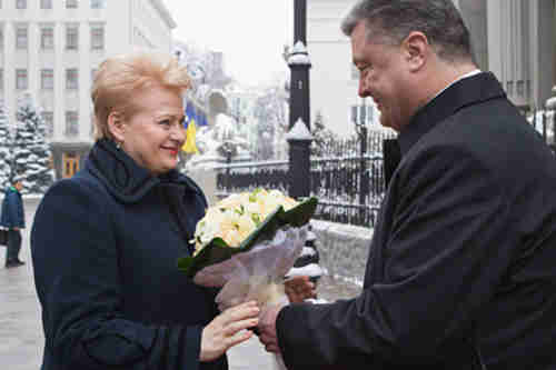 Ukraine's president Petro Poroshenko, right, greets Lithuania's president Dalia Grybauskaite in Kiev on Monday (AP)
