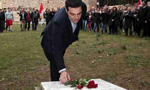 Alexis Tsipras places flowers on the National Resistance Memorial in Kaisariani on Monday. (EPA)