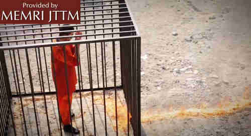 Muath al-Kaseasbeh, drenched in gasoline, watches as the flames approach his cage to burn him alive, in screen grab from ISIS video.  (Memri)