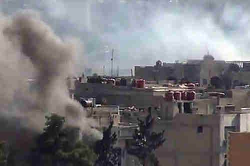 Smoke rises from buildings due to heavy clashes between Free Syrian army fighters and Syrian government forces.