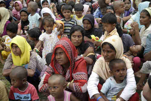 Ethnic Rohingya women and children gather to receive a meal in Indonesia on Saturday (AP)
