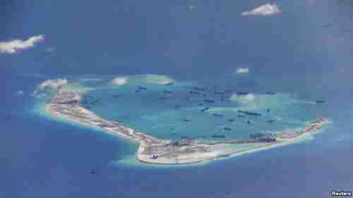 Numerous Chinese dredging vessels around an artificial island in May 2 photo taken by American P-8A Poseidon surveillance aircraft