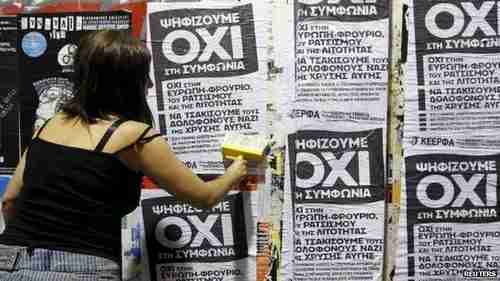 A woman in Athens puts up referendum campaign posters.  'OXI' means 'NO' in Greek.  (Reuters)