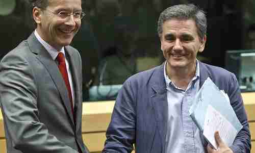 Euclid Tsakalotos (R) exposes his personal notes to cameras, where they can be photographed and examined (AP)