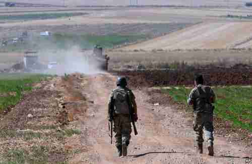 Turkish soldiers patrol near the border with Syria last month (AP)