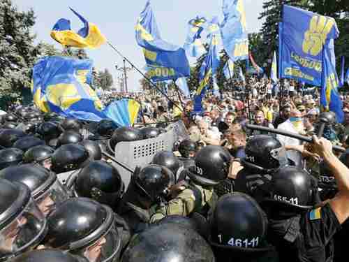 Demonstrators clash with police outside the Parliament in Kiev, Ukraine, on Monday (Reuters)
