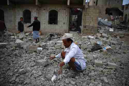 A man inspects the rubble of a house destroyed by a Saudi airstrike in Sanaa on Monday (AP)