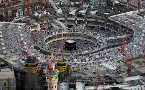 Aerial view of thousands of Muslim worshippers in the Grand Mosque in July, surrounded by construction cranes.  The rectangular building at the center is the Kabaa, the holiest shrine in Islam. (Telegraph)