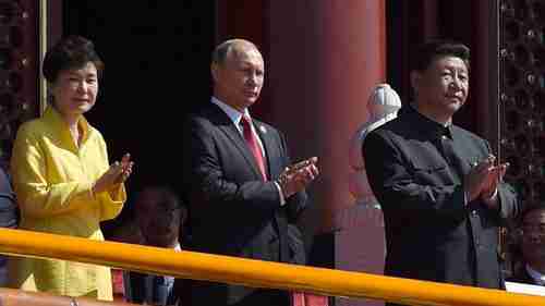 South Korea's president Park (L) holds a place of honor at China's victory parade, next to Vladimir Putin and Xi Jinping (R) on the reviewing stand (AP)