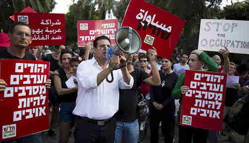 Ayman Odeh (center) leading an October 9 rally in Tel Aviv (Reuters)