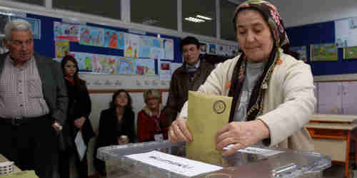 A Turkish woman casts her vote on Sunday in Ankara (AP)