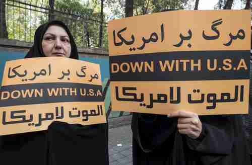Women hold anti-U.S.  banners commemorating Iran's 1979 attack on the U.S. embassy in Tehran (Reuters)