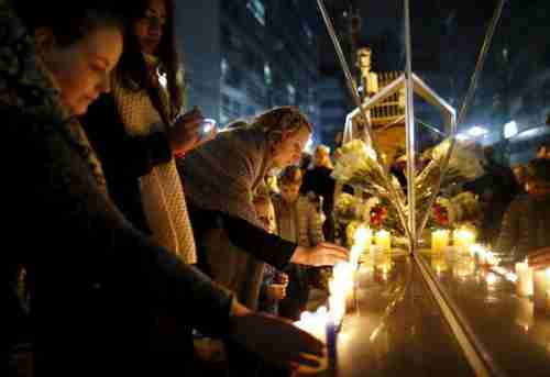 French people in Seoul, South Korea, light candles to pay tribute to the victims of the Paris attacks (Reuters)