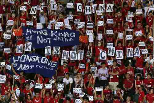 Hong Kong fans hold signs and banners saying 'BOO' and 'Hong Kong is not China' at Tuesday's match (Reuters)