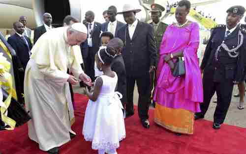 Pope Francis welcomed by Uganda's president Yoweri Museveni (at right with hat), in Kampala on Friday (AP)