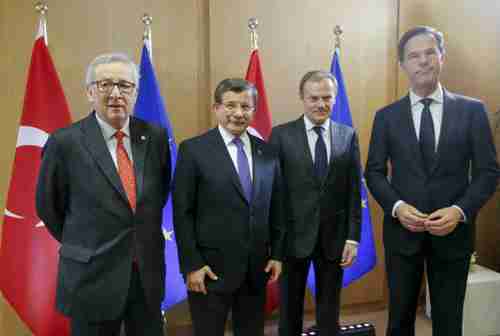 Friday in Brussels: The three EU officials look grim. The only one smiling is the Turkey's prime minister Ahmet Davutoglu, second from the left. (AFP)