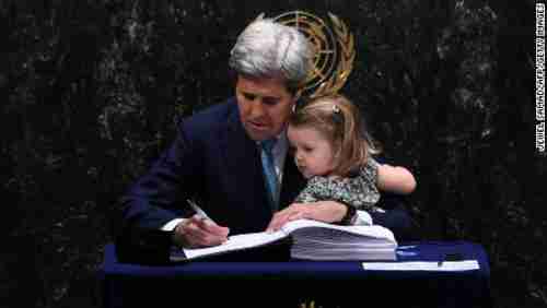 John Kerry and his granddaughter sign the climate change agreement