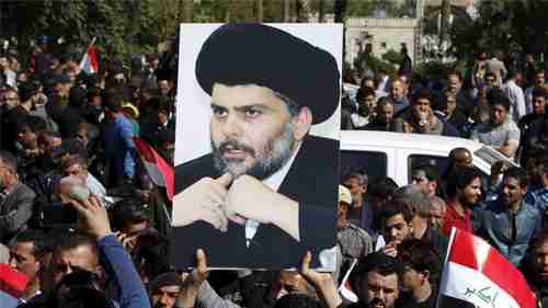 A demonstrator holds a picture of Moqtada al-Sadr during a demonstration in Baghdad (Reuters)