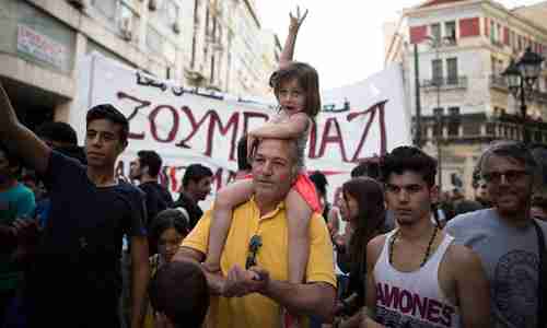 People demonstrate in support of refugees in Athens on Thursday (Guardian)