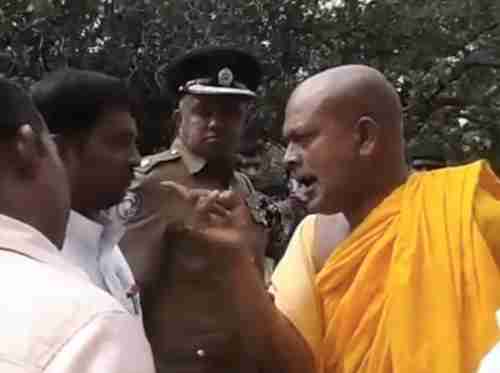 Image grab from video shows Buddhist monk using racist language to a Hindu Tamil civil servant, while policeman looks on and does nothing