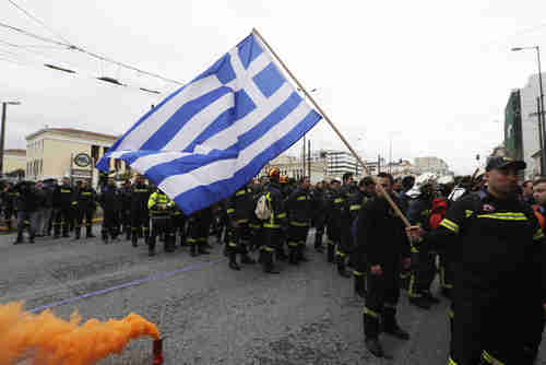 Hundreds of firefighters in uniform in Athens protest working conditions on Wednesday (AP)